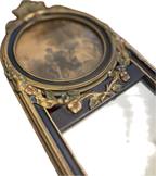 Antique oval-topped decorative mirror with an inset print and ornate frame.
