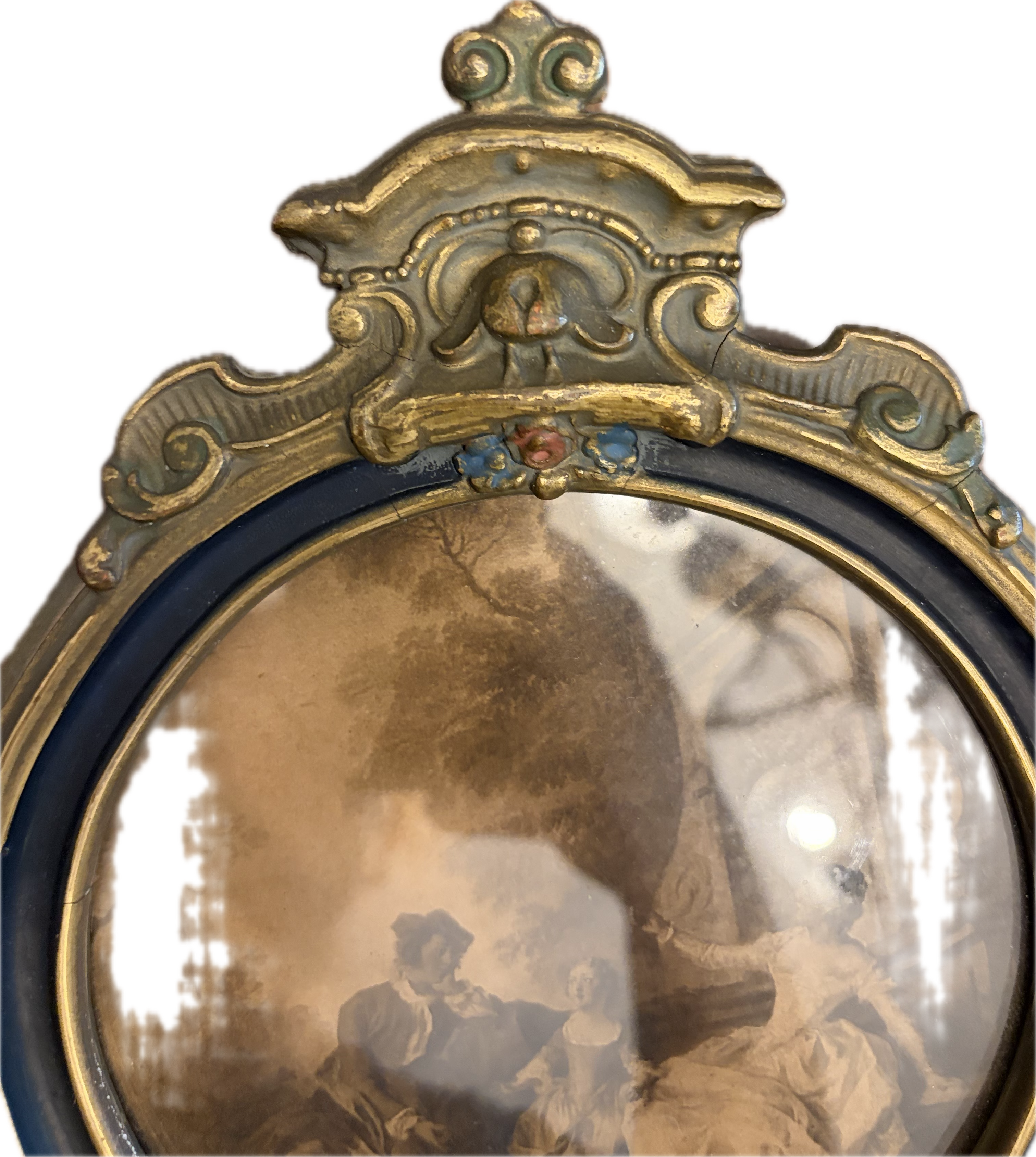 Antique oval-topped decorative mirror with an inset print and ornate frame.